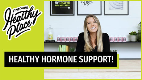 A video thumbnail from "The Healthy Place" featuring a smiling woman at a table with bold text reading "HEALTHY HORMONE SUPPORT!" and the brand’s logo on a lime green background.