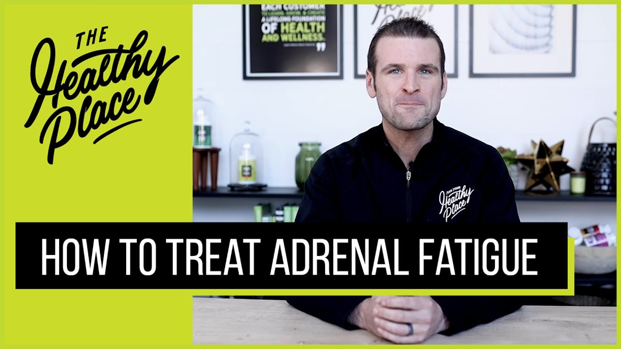 A video thumbnail from "The Healthy Place" featuring a man at a table with bold text reading "HOW TO TREAT ADRENAL FATIGUE" and the brand’s logo on a lime green background.