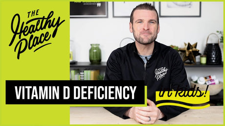 A video thumbnail from "The Healthy Place" featuring a man at a table with bold text reading "VITAMIN D DEFICIENCY in kids!" and the brand’s logo on a lime green background.