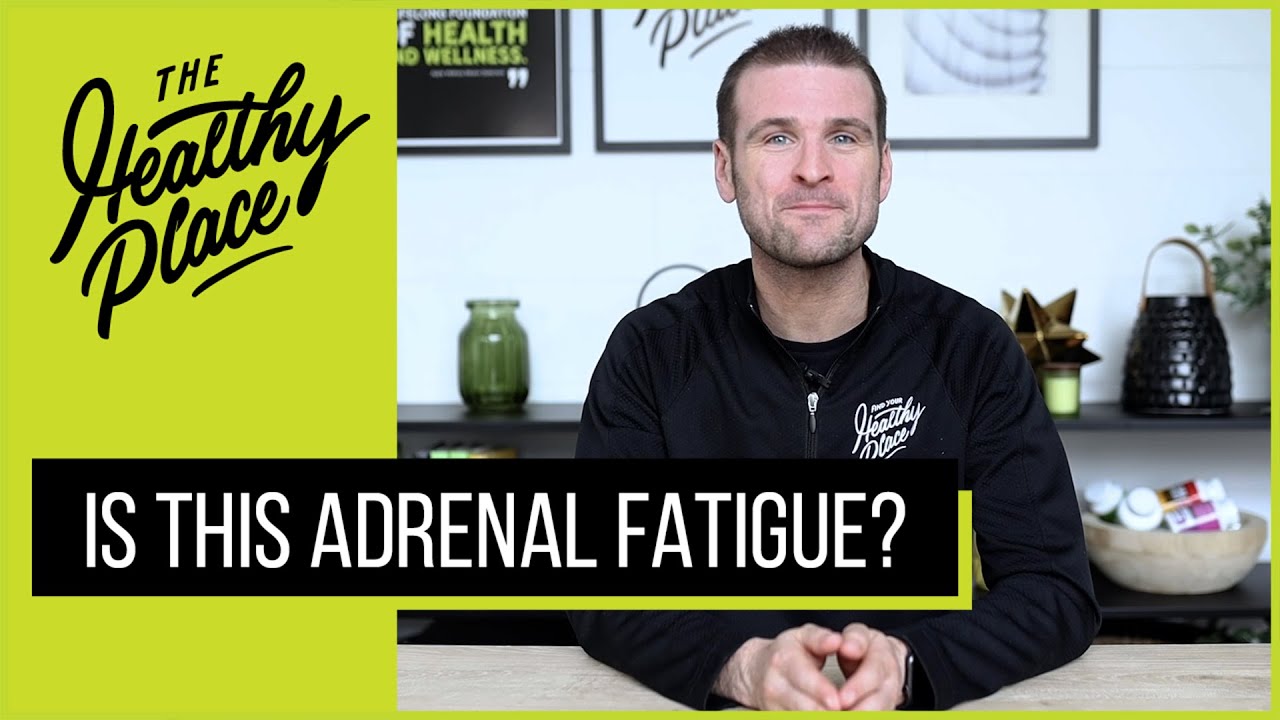 A video thumbnail from "The Healthy Place" featuring a man at a table with bold text reading "IS THIS ADRENAL FATIGUE?" and the brand’s logo on a lime green background.