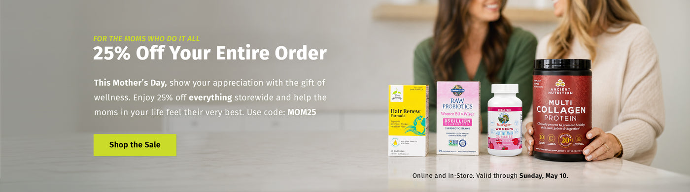 Mother’s Day promotional banner featuring the text “25% Off Your Entire Order” and a “Shop the Sale” button. Additional text mentions a storewide sale using code “MOM25,” valid through Sunday, May 10. The image shows four supplement products on a countertop in front of two blurred women in the background.