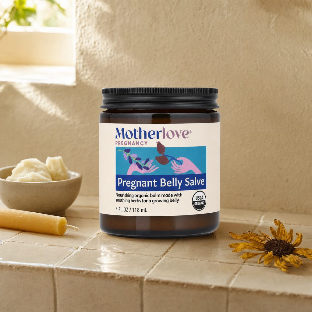 Pregnant woman applying Motherlove Pregnant Belly Salve to her belly