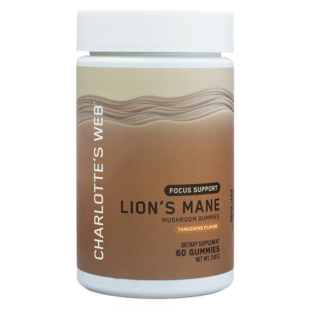 The front label of Charlotte's Web Focus Support Lion's Mane Mushroom Gummies 60 Gummies in tangerine flavor. The design features a wavy beige and brown background, with the Charlotte's Web logo printed vertically on the side. The label highlights the product’s focus support benefits and states it contains 60 gummies.