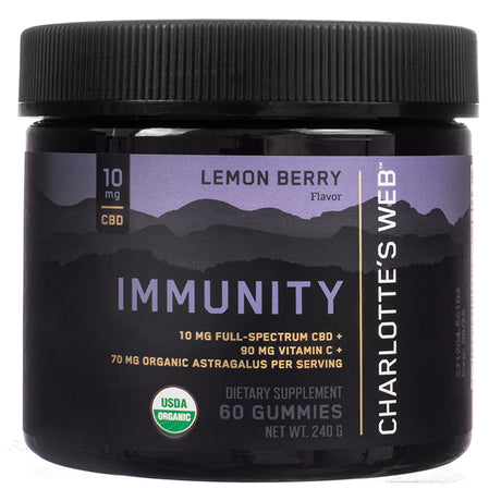 Jar of Charlotte’s Web Immunity Gummies in Lemon Berry flavor, containing 60 gummies. The label highlights 10 mg full-spectrum CBD, 90 mg vitamin C, and 70 mg organic astragalus per serving. Features USDA Organic certification and sleek mountain silhouette design with purple and black tones.