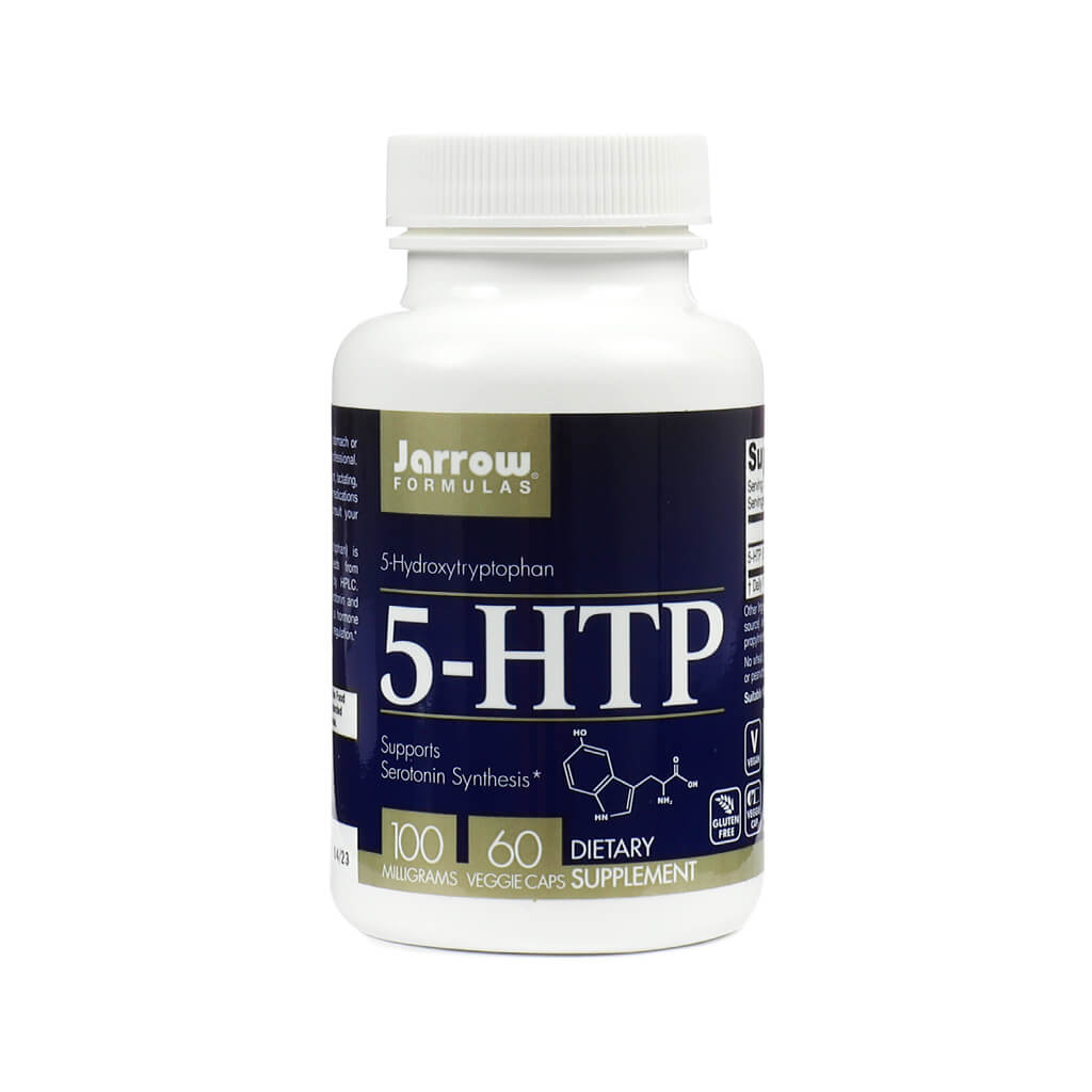 A white plastic bottle of Jarrow Formulas 5-HTP dietary supplement containing 60 veggie capsules at 100 milligrams each. The dark blue label highlights that it supports serotonin synthesis and includes the chemical structure of 5-Hydroxytryptophan.