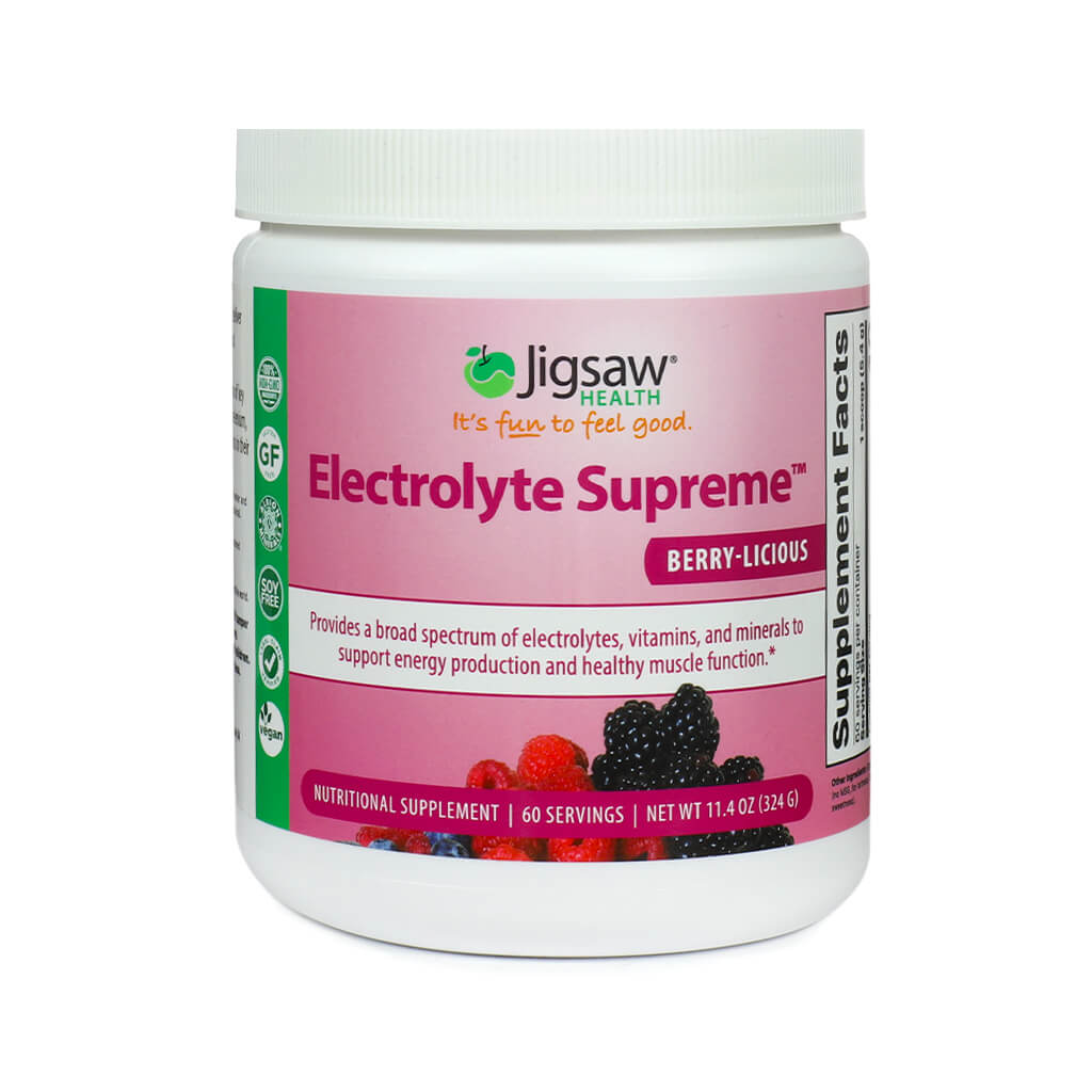 A white canister of Jigsaw Health's Electrolyte Supreme in the Berry-Licious flavor, featuring a bright pink label with mixed berries at the bottom and health claims about supporting energy and muscle function. The container notes 60 servings and a net weight of 11.4 oz (324g).