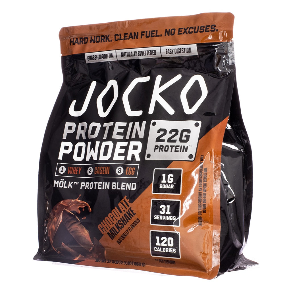 A powerful black and bronze-toned bag of Jocko Mölk Chocolate Milkshake Protein Powder featuring a swirl of chocolate. It offers 22g protein, 1g sugar, 120 calories, and 31 servings, formulated with whey, casein, and egg protein sources.