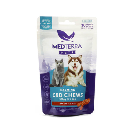 Bag of Medterra Pets Calming CBD Chews featuring a photo of a dog and a cat. The package highlights 10mg of CBD per chew, 300mg per bag, and a bacon flavor with 30 soft chews. It is labeled THC-free, grain-free, and non-GMO.