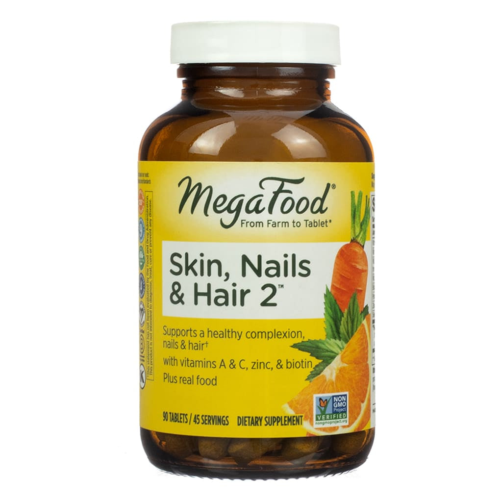 MegaFood Skin, Nails & Hair 2 in a 90-tablet bottle with an illustrated label of carrots and oranges. The multivitamin supports a healthy appearance with key nutrients like vitamins A and C, zinc, and biotin, formulated from real food sources.