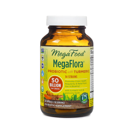 A bottle of MegaFood MegaFlora Probiotic with Turmeric, featuring a yellow label with text highlighting "50 billion live cultures," "14 strains," and benefits for colon health, gas, and bloating. The amber glass bottle contains 60 capsules, offering 30 servings, and emphasizes turmeric root and prebiotic foods.
