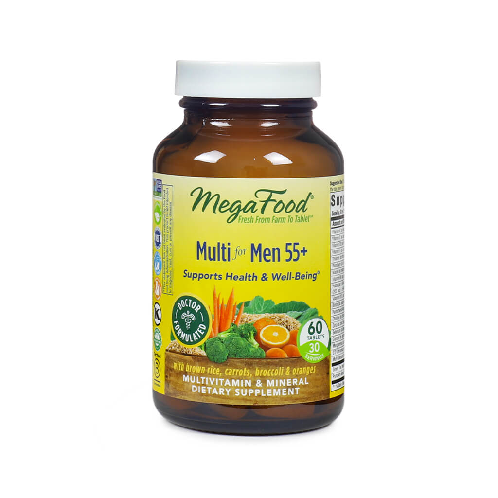 MegaFood Multi for Men 55+ bottle containing 60 tablets, with an amber glass body and white cap. The label highlights support for health and well-being, featuring images of carrots, broccoli, oranges, and brown rice, and notes the formula is doctor-formulated.