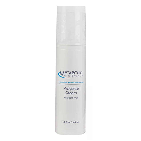 A white 3.5 fl oz (100 ml) bottle of Metabolic Maintenance ProgestE Cream, labeled as “Balancing and Rejuvenating” and “Paraben Free.” The sleek design features blue and black text on a minimalist background, promoting a clean, hormone-supportive topical cream.
