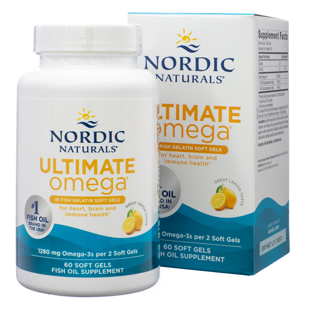 A white bottle of Nordic Naturals Ultimate Omega, placed in front of its matching box. The label highlights fish gelatin soft gels with 1,280 mg Omega-3s per 2 soft gels, formulated for heart, brain, and immune health. The product contains 60 soft gels and features a great lemon taste. The box in the background displays supplement facts and additional product details.