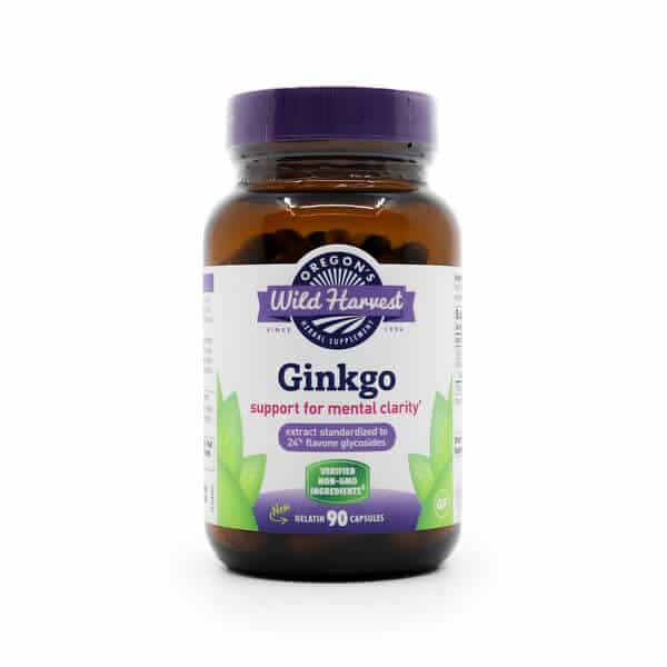 Amber glass bottle with a purple lid labeled “Oregon’s Wild Harvest Ginkgo.” The label highlights “support for mental clarity*” and “extract standardized to 24% flavone glycosides,” with icons noting it's verified non-GMO and gluten-free. Contains 90 gelatin capsules with green leaf graphics on the label.