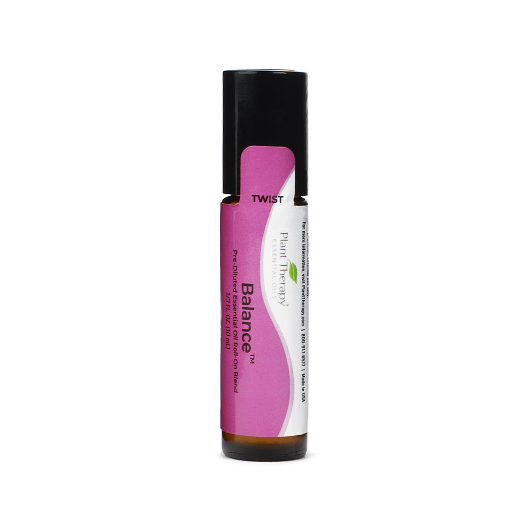 A small amber glass roll-on bottle labeled “Balance” from Plant Therapy, featuring a pink and white label and black twist cap. The text notes it’s a pre-diluted essential oil roll-on blend in a 10 ml size.