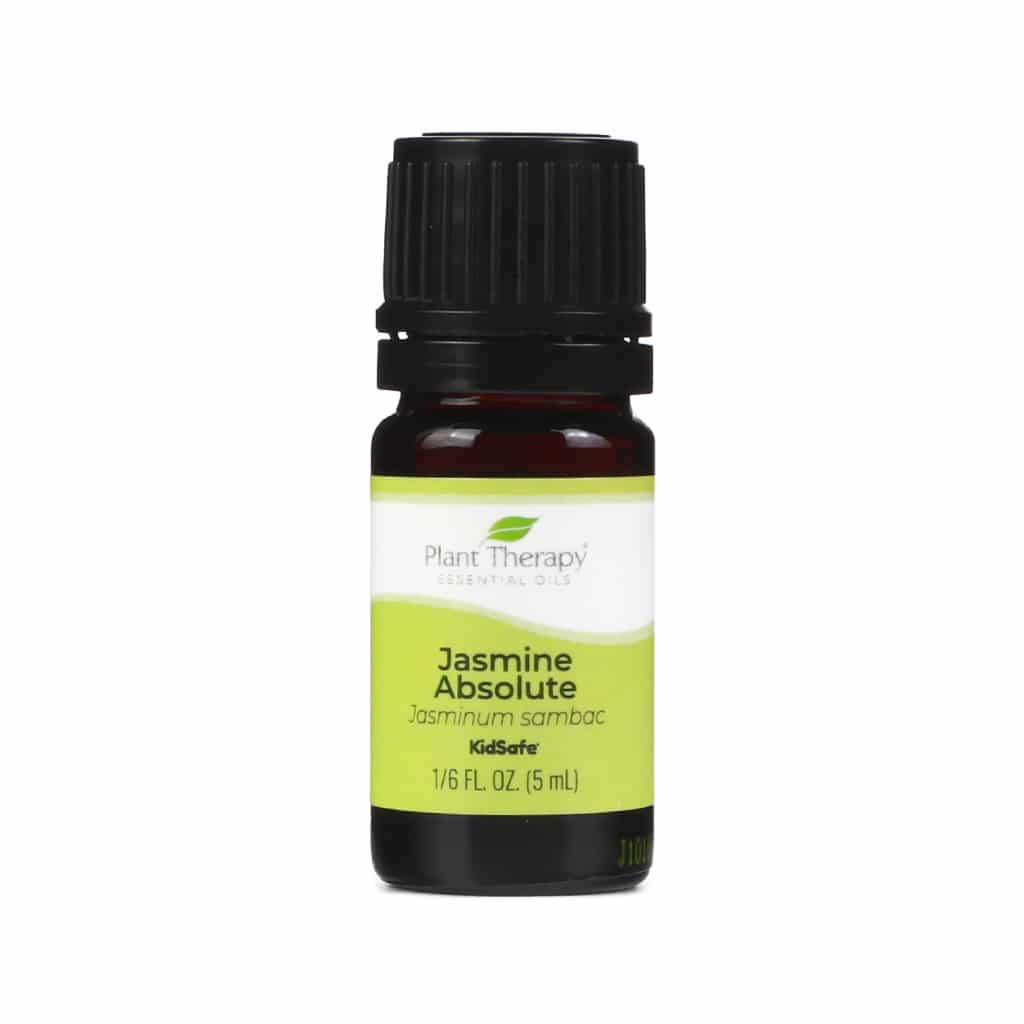 A small brown glass bottle with a black cap. The label is lime green and white with "Plant Therapy Essential Oils," "Jasmine Absolute," and "Jasminum sambac." It includes "KidSafe."