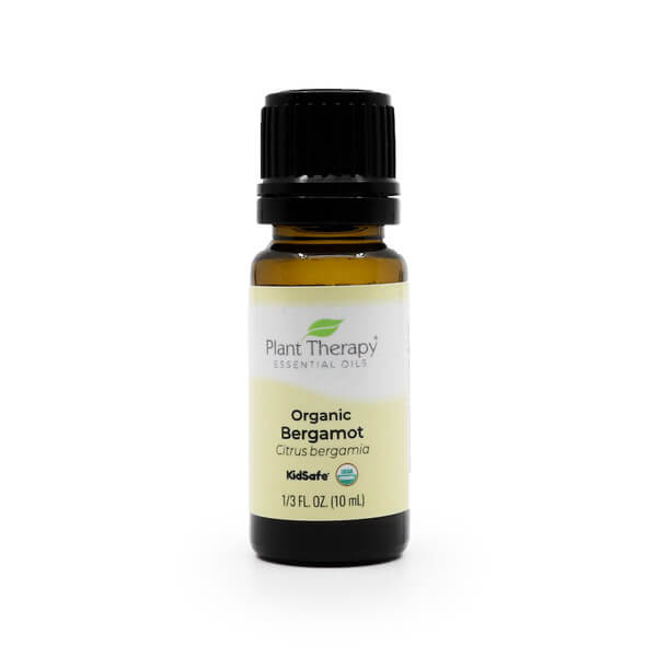 A 10ml / 1/3 fluid ounce amber glass bottle of Plant Therapy Organic Bergamot Essential Oil with a black cap. The label is light yellow and white, displaying the brand name, "Organic Bergamot," and "Citrus bergamia." It includes "KidSafe" and USDA Organic certification.