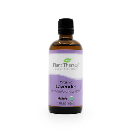 A 100ml amber glass bottle of Plant Therapy Organic Lavender Essential Oil with a black cap. The label is purple and white, showing the brand name, "Organic Lavender," and "Lavandula angustifolia." It includes "KidSafe" and USDA Organic certification.