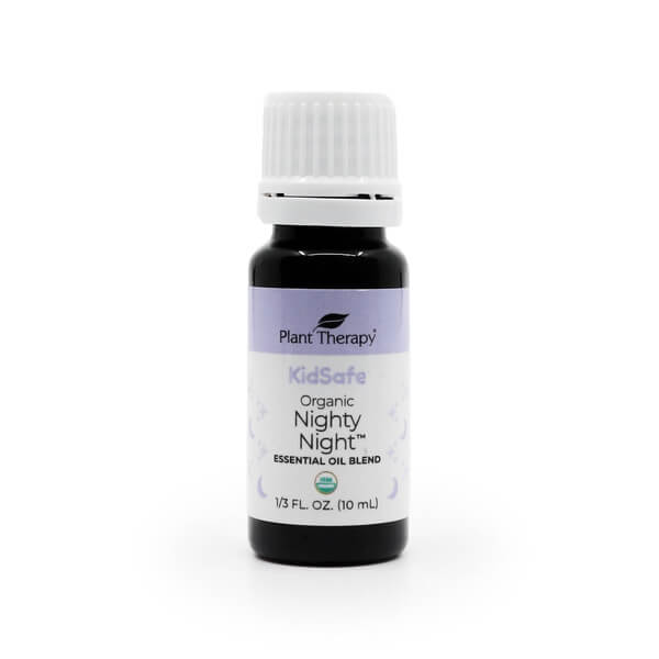 Plant Therapy Organic Nighty Night Essential Oil, 10 mL bottle. The dark amber glass bottle has a white cap and a soft purple and white label featuring the "KidSafe" certification and USDA Organic seal. This calming blend is designed to promote relaxation and restful sleep.