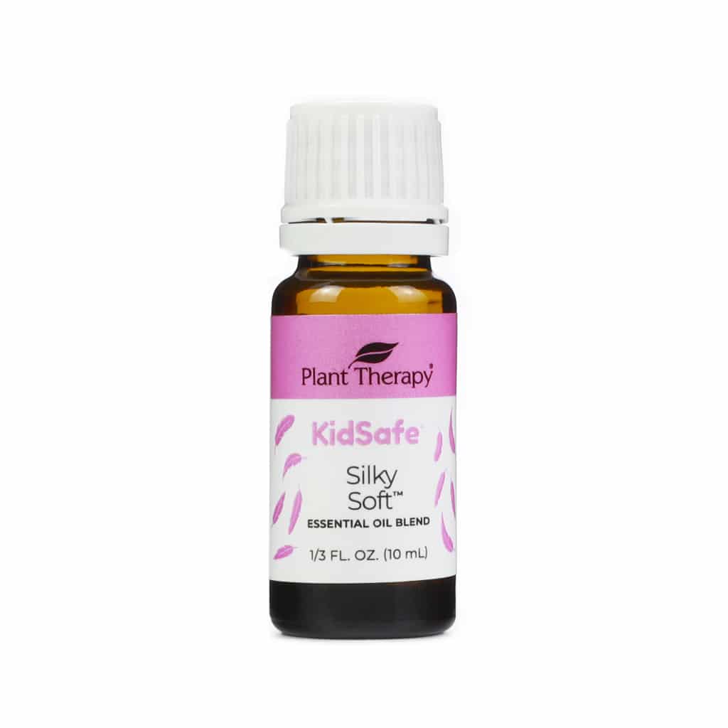 Plant Therapy Silky Soft KidSafe Essential Oil Blend, 10 mL bottle. The amber glass bottle has a white cap and a pink and white label with feather illustrations. Designed for gentle skin nourishment, this blend is part of Plant Therapy's KidSafe collection.