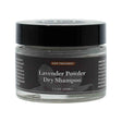 A small 1.3 oz glass jar of Lavender Powder Dry Shampoo labeled as a hair treatment, featuring a black screw-on lid and dark label with light gray text. The packaging suggests a botanical formula designed to refresh hair without water.