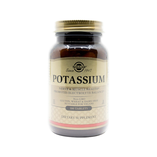 A brown glass bottle of Solgar Potassium dietary supplement. The label notes benefits for nerve and muscle health, electrolyte balance, and highlights that it is non-GMO, gluten, wheat, and dairy free, and suitable for vegans with 100 tablets per bottle.
