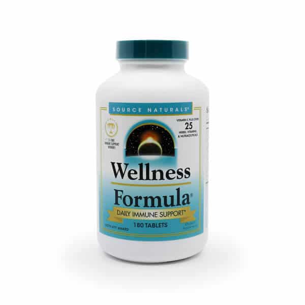 Source Naturals Wellness Formula in a white plastic bottle with a teal cap. The label features a blue gradient design and highlights "Daily Immune Support" with a blend of 25 vitamins, minerals, and herbs. A central image shows a rising sun over a horizon, symbolizing wellness. The bottle contains 180 tablets.