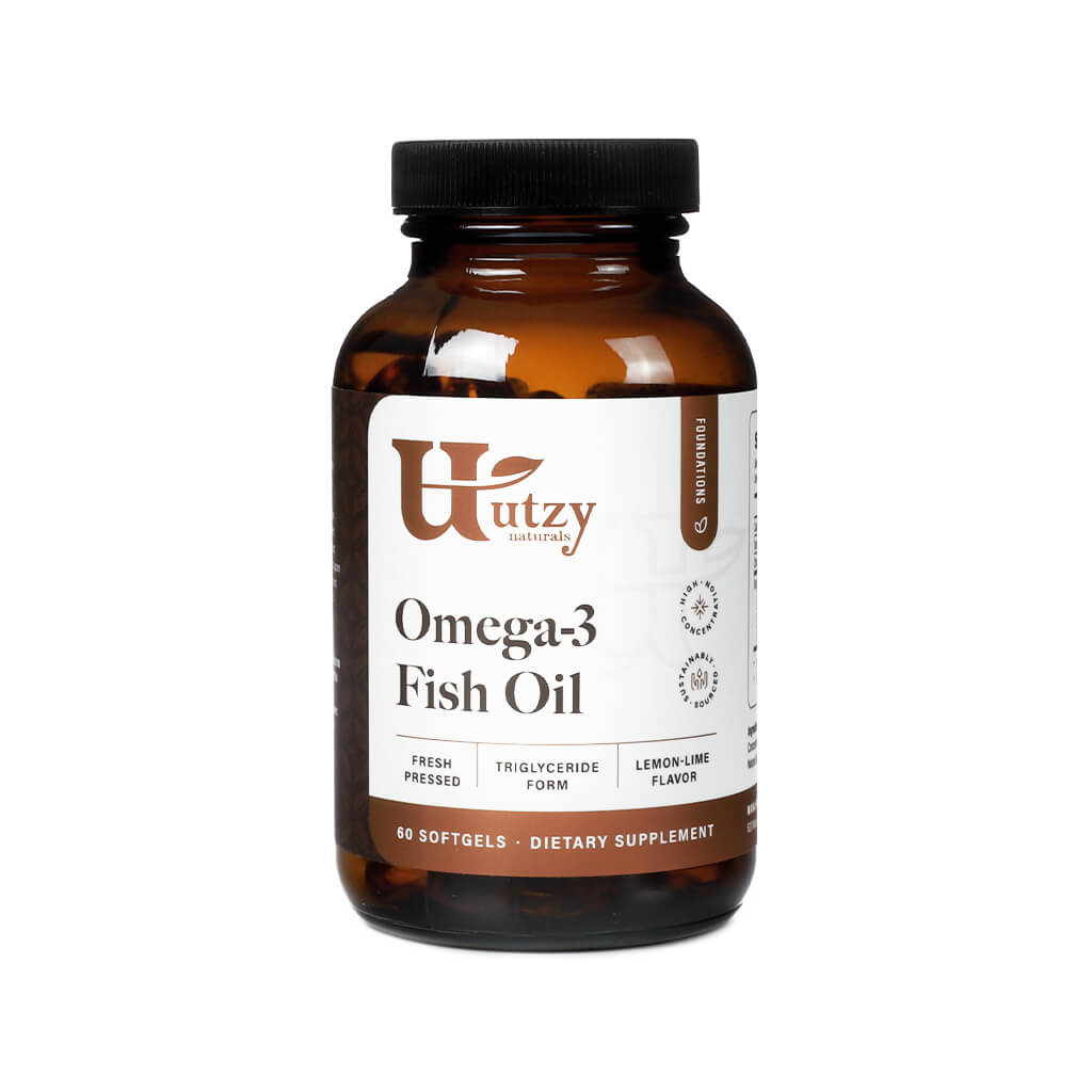 Utzy Naturals Omega-3 Fish Oil bottle containing 60 softgels, labeled as a dietary supplement with fresh-pressed, triglyceride-form fish oil and a lemon-lime flavor. The packaging features a brown glass bottle with a black cap and a white label with brown and gold accents.