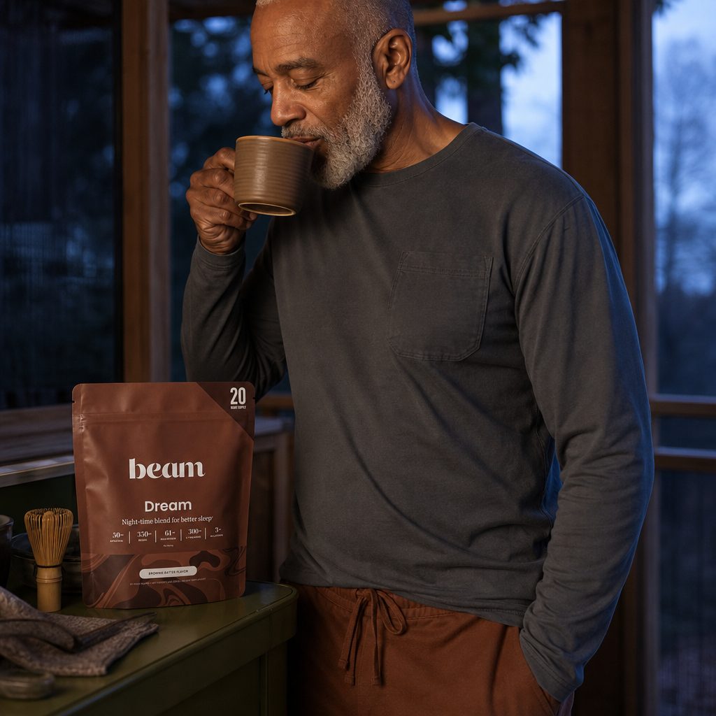 Beam Dream Powder Cinnamon Cocoa pouch beside a warm cocoa drink and cinnamon