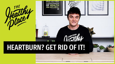 A video thumbnail from "The Healthy Place" featuring a smiling young man at a table with bold text reading "HEARTBURN? GET RID OF IT!" and the brand’s logo on a lime green background.