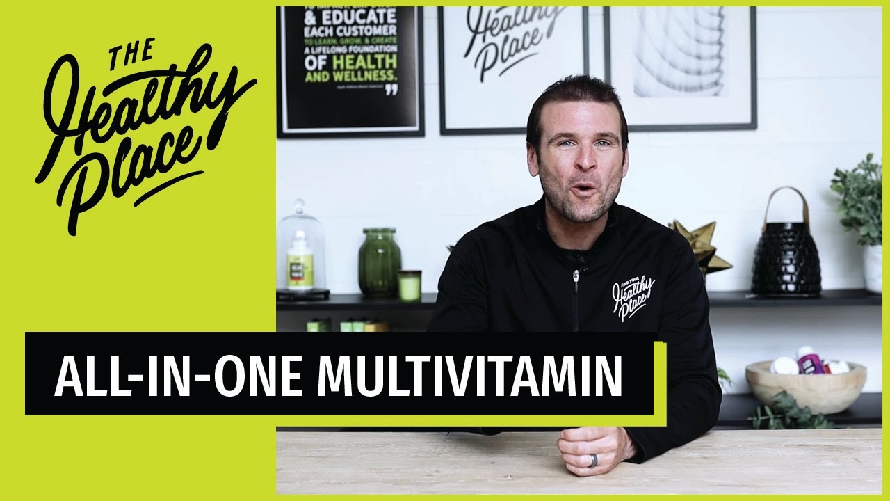A video thumbnail from "The Healthy Place" featuring a man at a table with bold text reading "ALL-IN-ONE MULTIVITAMIN" and the brand’s logo on a lime green background.