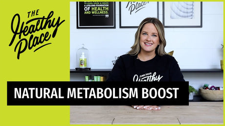 A woman in a 'Find Your Healthy Place' sweatshirt sits at a table with a wellness-themed background. Text overlay reads 'NATURAL METABOLISM BOOST.'
