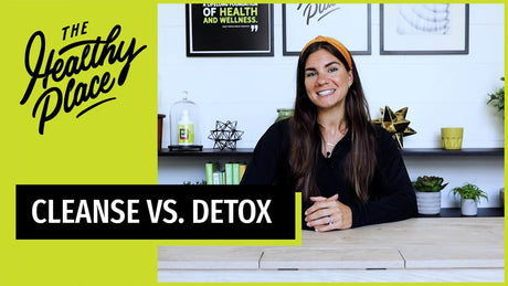A video thumbnail from "The Healthy Place" featuring a smiling woman at a table with bold text reading "CLEANSE VS. DETOX" and the brand’s logo on a lime green background.