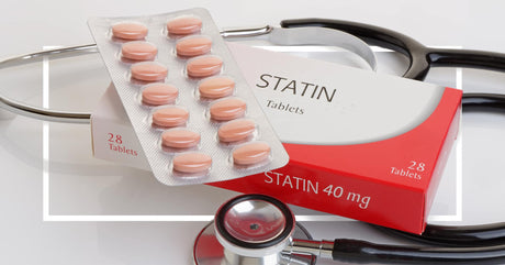 A red and white box labeled "Statin 40 mg Tablets" with an open blister pack of round, peach-colored tablets on top. The image also includes a stethoscope to emphasize medical usage.