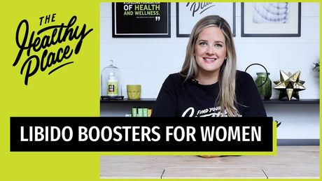 A woman in a 'Find Your Healthy Place' sweatshirt sits at a table with a wellness-themed background. Text overlay reads 'LIBIDO BOOSTERS FOR WOMEN.'