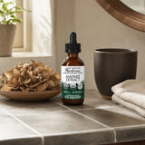 Host Defense Maitake Extract 2 fl oz dropper bottle shown in a wellness routine scene