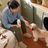 Vital Planet Skin & Coat Chewable Tablets lifestyle scene with woman and dog