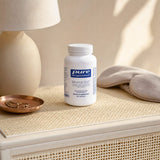 Pure Encapsulations Mineral 650 bottle beside breakfast plate and water glass