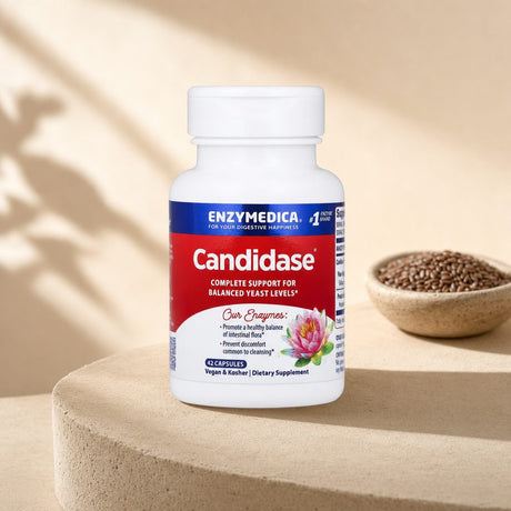 Enzymedica Candidase 42 Capsules on a clean kitchen counter with a glass nearby