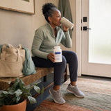 Woman setting Pure Encapsulations Mineral 650 near a weekly supplement organizer