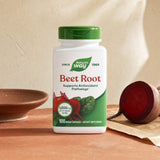 Nature's Way Beet Root Capsules bottle on kitchen counter with red vegetables