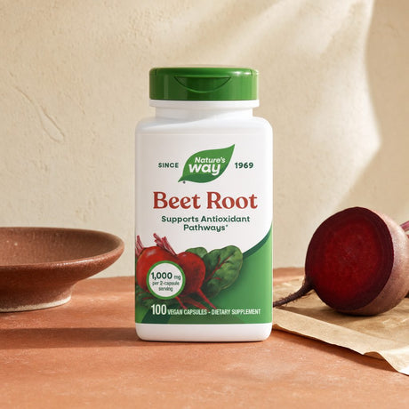 Nature's Way Beet Root Capsules bottle on kitchen counter with red vegetables