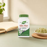 Nature's Way Alfa-Max bottle displayed with fresh greens and wellness items