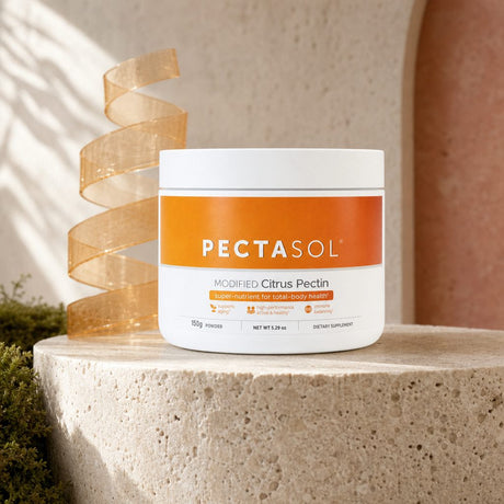 EcoNugenics PectaSol Modified Citrus Pectin Powder beside a scoop and glass of water