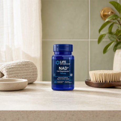 Life Extension NAD+ Cell Regenerator bottle on a kitchen counter with a glass of water