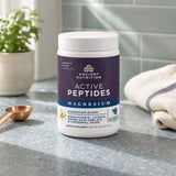 Ancient Nutrition Active Peptides Magnesium Powder beside a prepared Blueberry Peppermint drink