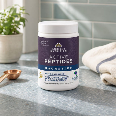 Ancient Nutrition Active Peptides Magnesium Powder beside a prepared Blueberry Peppermint drink