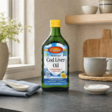 Carlson Norwegian Cod Liver Oil Lemon bottle with teaspoon and lemon on kitchen counter