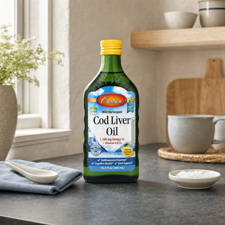 Carlson Norwegian Cod Liver Oil Lemon bottle with teaspoon and lemon on kitchen counter