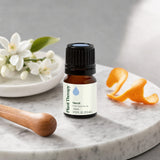 Plant Therapy Neroli Essential Oil bottle beside diffuser and natural aromatherapy items